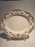 Front view of Grindley floral oval platter on stand