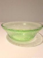 Side view showing flared profile, etched pattern, green uranium glass
