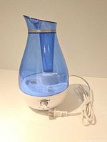 Assembled humidifier showing blue tank, white base, control knob and power cord