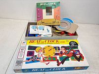Box open showing interior components: discs, cones, cards, instruction sheet