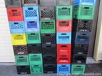 Full front view of 26 stacked milk crates showing color variety and lattice design