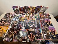 Tabletop spread of 30+ Xena comics showing fronts and issue variety