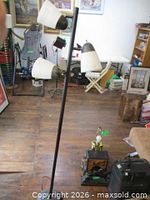 Full view of lamp showing pole, three shades, base