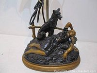 Full view of sculptural lamp base with woman and dog figures