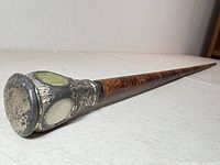 Full view of swagger stick showing silver-plated grip and wooden shaft