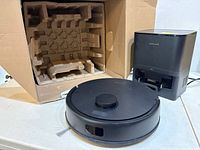 Robot vacuum, auto-empty base, open box with insert