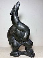 Front view of black stone dancing bear sculpture