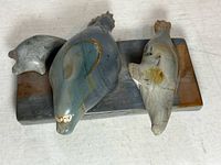Top view showing three carved seals on stone base