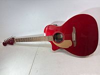 Front view of candy apple red Fender Newporter Player left-hand acoustic-electric guitar