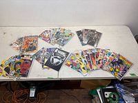 Full lot overview of all bagged comics laid on table