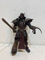 Front view of samurai Spawn figure holding sword and claw weapon