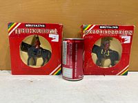 Front of both boxed figures beside soda can for scale