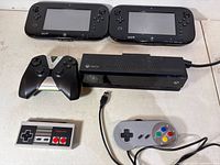 Front view of all six gaming controllers and Kinect bar