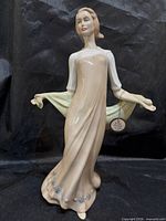 Front view of Royal Doulton Enchanting Evening figurine with tag visible