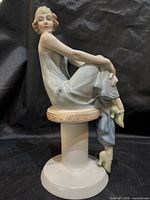 Full view of figurine angled left, shows overall design and condition