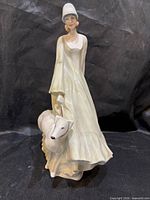 Front view of Royal Doulton figurine showing woman and dog
