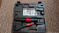 Open case showing hydraulic crimping tool, dies and instructions