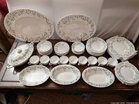 Full dinnerware set laid out on table