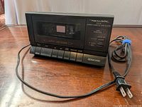 Front view of Realistic SCP-32 cassette player with attached AC power cord on table