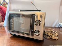 Front view showing screen, tuner dials, Sony Trinitron branding and AC cord