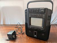 Front view of Yorx 1545 unit with screen, cassette deck, controls and AC adapter