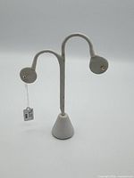 White display stand with tag for the earrings