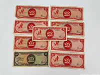 Ten banknotes laid out showing denominations and overall wear
