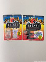 Front view of both sealed Batman toys