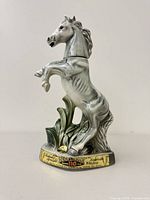 Full view of the white horse decanter on base