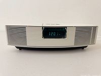 Front view showing clock display and speaker grille