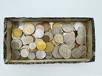 Top view of entire box showing quantity and variety of coins