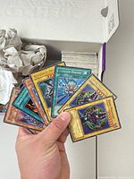 Fan of selected Yu-Gi-Oh! cards including Monster Reborn and others, plus view into box