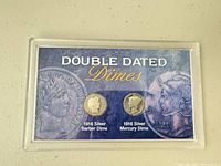 Front of acrylic holder showing both coins and title card