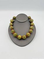 Full view of necklace on bust displaying bead size and colour