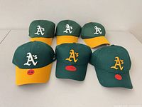 All six green Oakland A’s caps showing visor color variations and logo embroidery