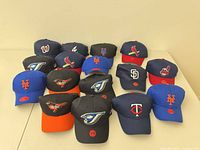 All 16 caps displayed in four rows on table