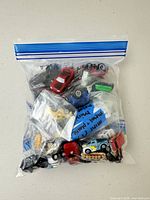 One sealed resealable bag filled with small toy vehicles