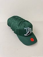 Stack of identical green Tampa Bay Rays hats front to back