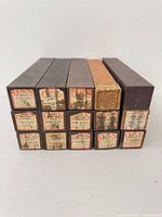 Stack of 15 boxed piano rolls