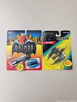 Front view of both sealed Batman vehicles on cards