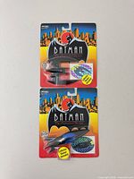 Front view of both sealed Batplane and Batboat packages