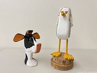 Seagull and cow figurines together front view