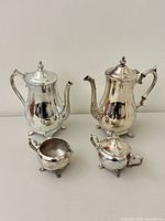 Full view of all four silver-plated pieces