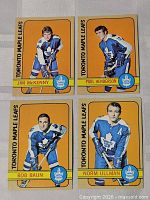 Four 1972-73 Topps Toronto Maple Leafs cards laid out: McKenny, Henderson, Baun, Ullman