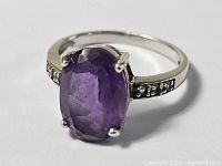 Top view of sterling silver ring with oval amethyst gemstone