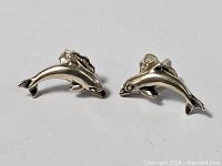 Front view of both dolphin earrings