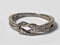 Front view of sterling silver infinity knot ring with pavé stones