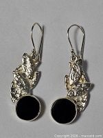 Front view of both earrings showing onyx stones and leaf design