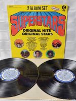 Front view of sleeve and both LPs showing cover art and record labels