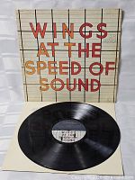 Front cover displayed with vinyl record on inner sleeve